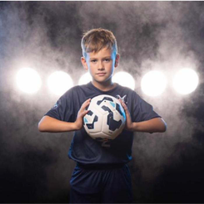 My Player Profile at Me@Now — Young football player holding soccer ball